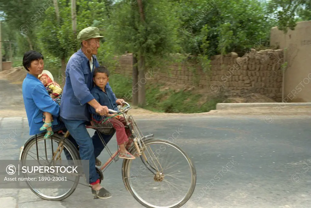 Family riding on a bicycle in Ningxia, China, Asia