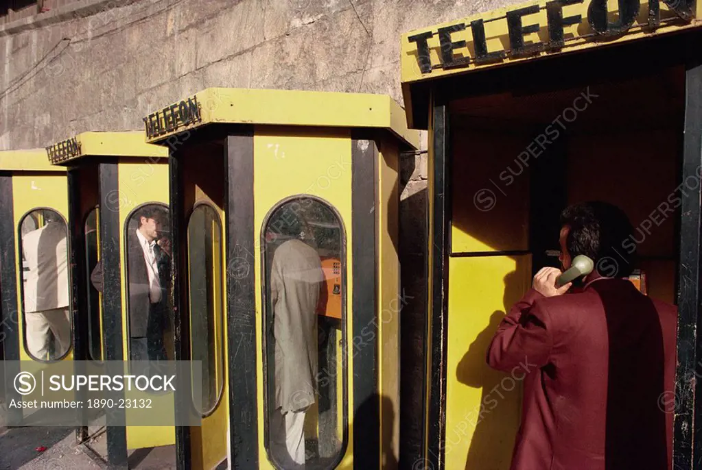 People in telephone kiosks on Galata Bridge, Istanbul, Turkey, Europe