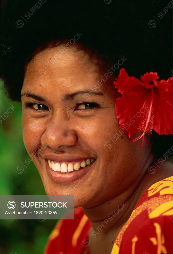 Portrait of a Melanesian girl with a red hibiscus flower in her hair on Qamea Island, Fiji, Pacific Islands, Pacific