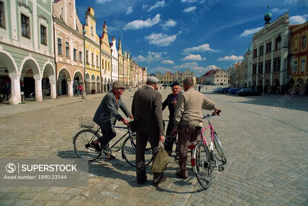 A group of elderly men talking in the 16th century town square in Telc, UNESCO World Heritage Site, South Moravia, Czech Republic, Europe