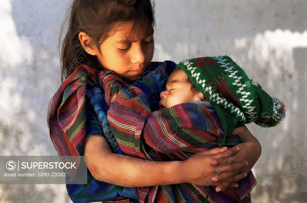 Little girl holding sleeping baby, Santa Catarina Palopo, Guatemala, Central America