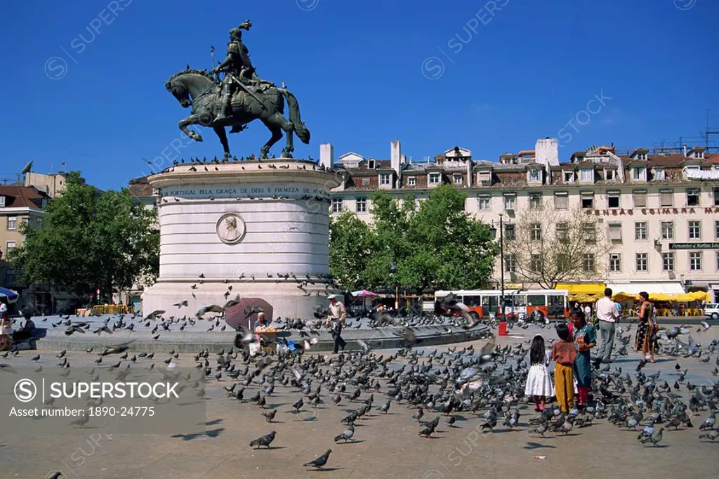 Children feed pigeons in Figueira Square in Lisbon, Portugal, Europe