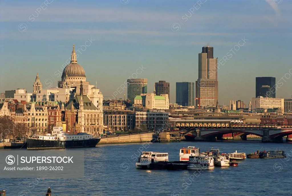 City skyline, including St. Paul´s Cathedral, the NatWest Tower and Southwark Bridge, from across the Thames at dusk, London, England, United Kingdom,...