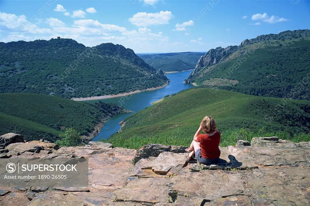Walker at Cerro Gimio viewpoint looking to lake and hills in the Monfrague Natural Park, Caceres, Extremadura, Spain, Europe