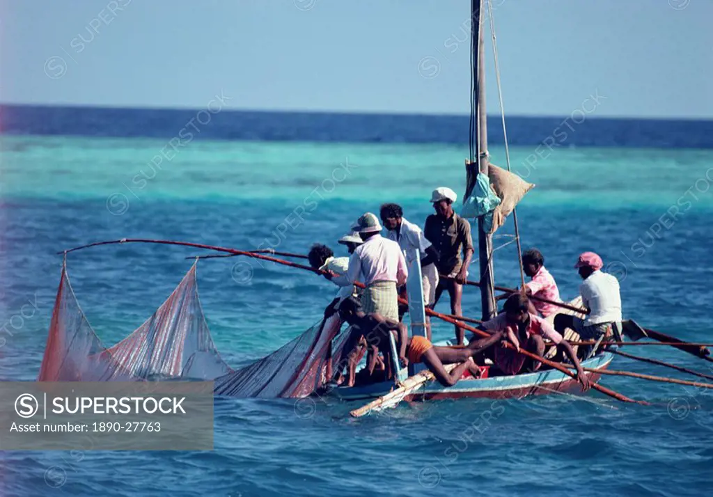 Crowded fishing boat raising its nets, Maldives, Indian Ocean, Asia