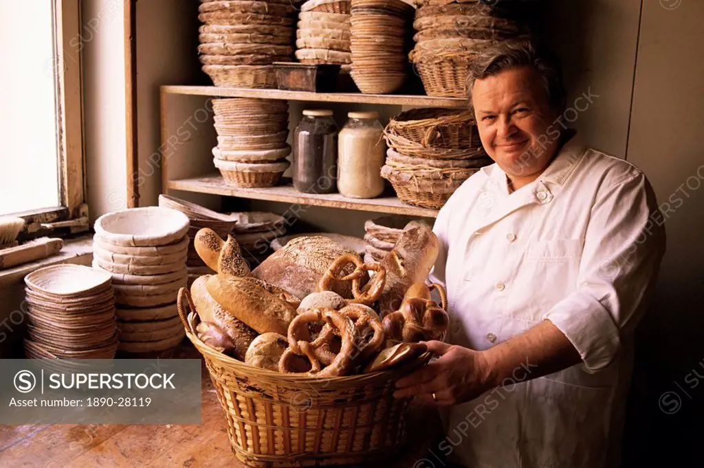 Baker with selection of bread, France, Europe