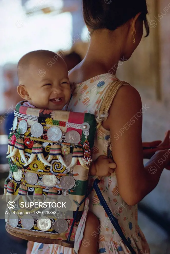 Kenyah woman with baby in a traditional carrier, Kalimantan, Borneo, Indonesia, Asia