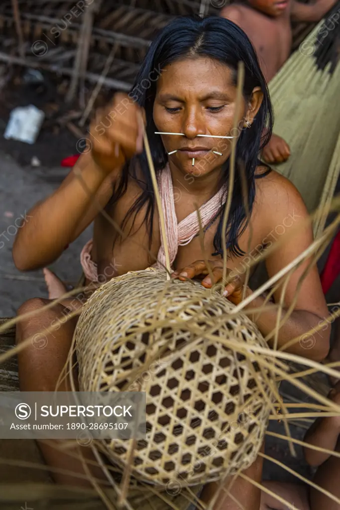 Woman from the Yanomami tribe weaving a basket, southern Venezuela, South America