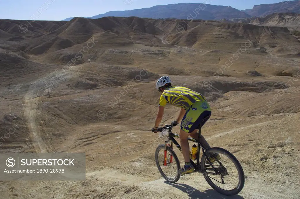 Back view of competitior riding downhill in the Mount Sodom International Mountain Bike Race, Dead Sea area, Israel, Middle East