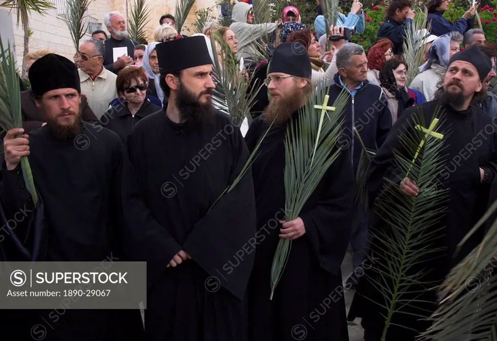 Group of priests holding palms and crosses during Orthodox Easter Palm procession from Betphage to the Old City, Mount of Olives, Jerusalem, Israel, M...