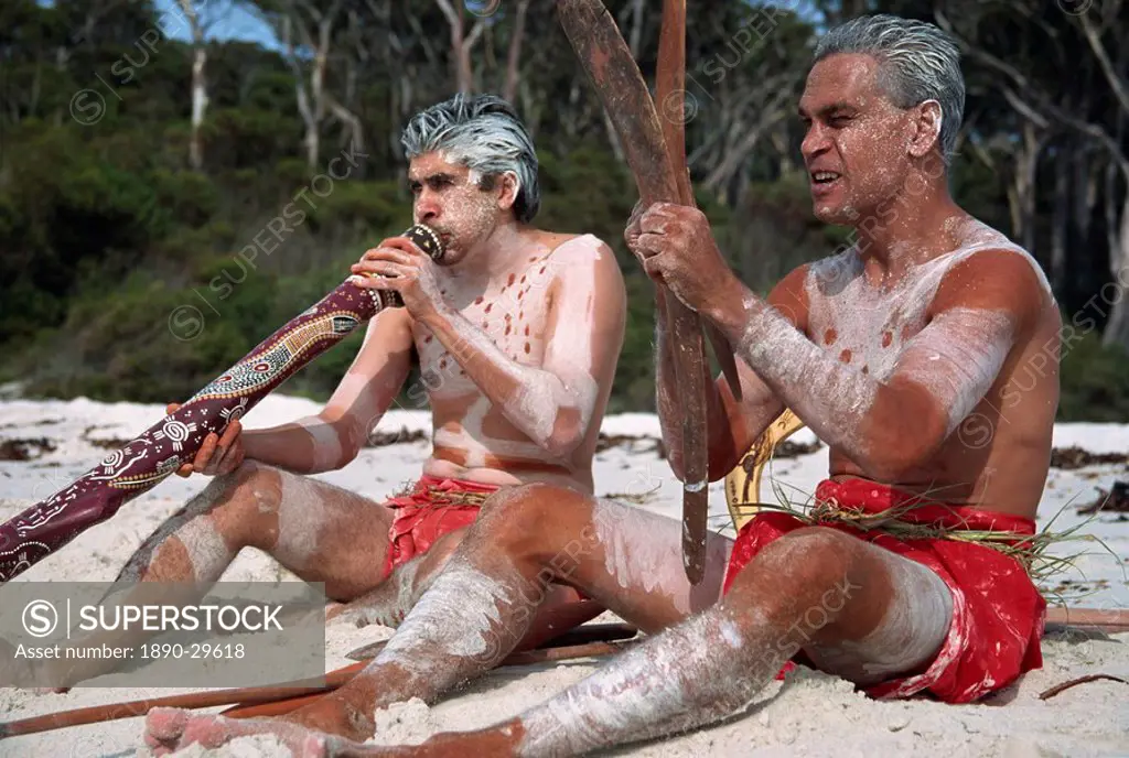 Two men with Aboriginal digeridoo and boomerang at Jervis Bay, Australia, Pacific
