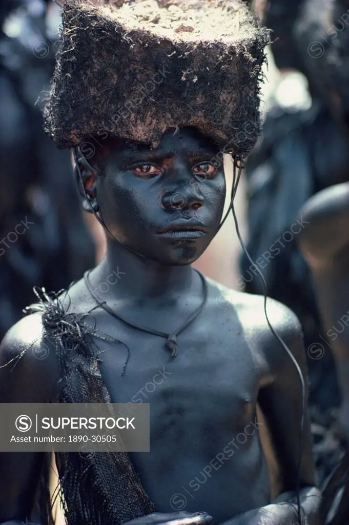 Portrait of a boy covered in pig_fat and charcoal in Papua New Guinea, Pacific Islands, Pacific