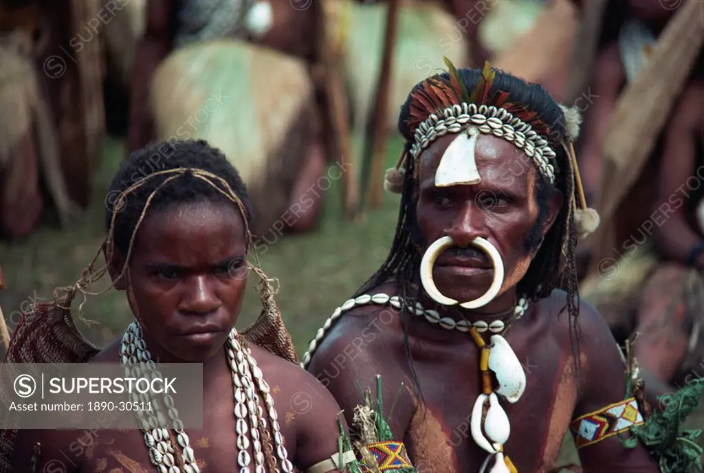 Portrait of a man and wife with bone and cowry shell jewellery and decoration at a Sing_sing in Papua New Guinea, Pacific Islands, Pacific