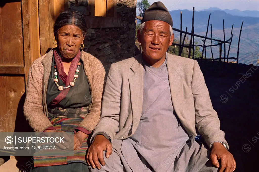 Portrait of an elderly Sherpa couple in traditional clothing, sitting outdoors, look at the camera, at Solu Khumbu, Nepal, Asia