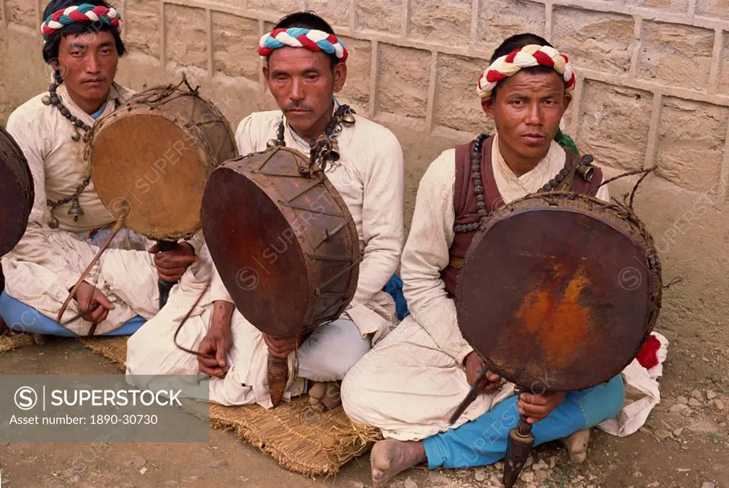 Portrait of three Dami Jankris, holistic healers native to Nepal, in traditional clothing, with drums, at the Save the Children funded health post at ...