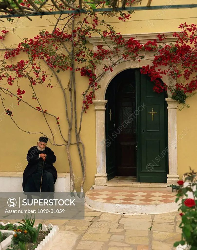 Resident monk at chapel door, Paleokastritsa Monastery, Corfu, Ionian Islands, Greek Islands, Greece, Europe