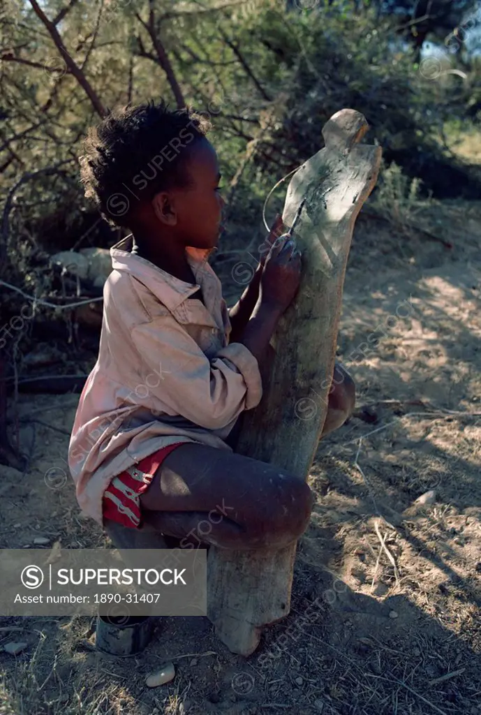 Portrait of child, outdoors, drawing on wood, Somalia, Africa
