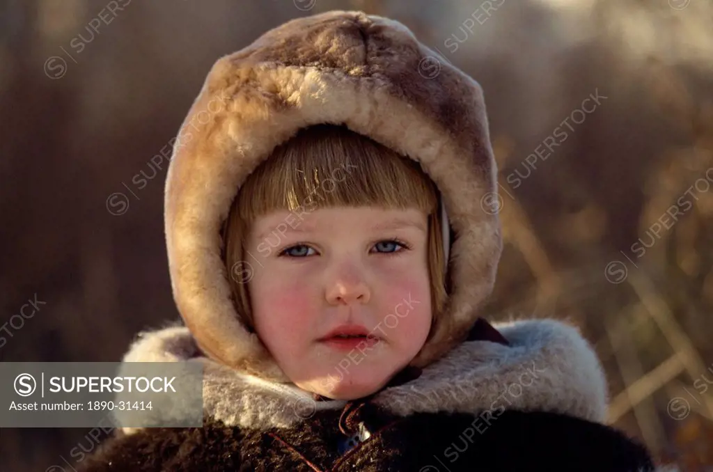 Head and shoulders portrait of young Russian girl wearing a fur hat, looking at the camera, Moscow, Russia, Europe