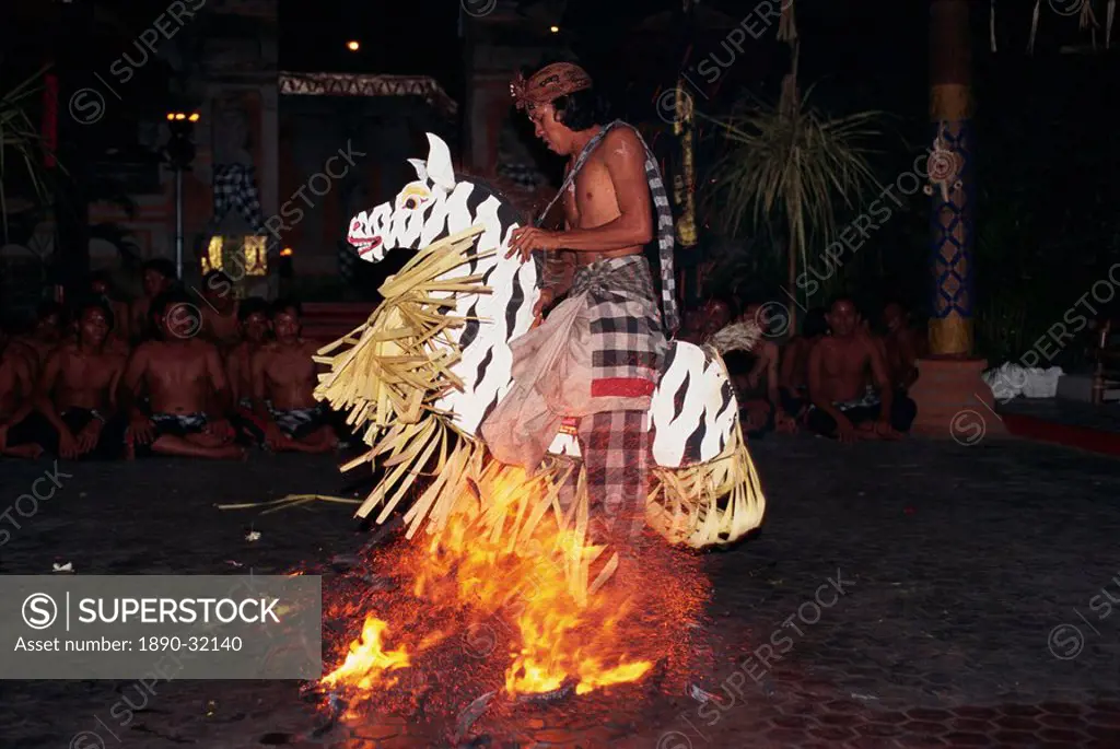 Portrait of a man riding a straw horse, walking on coals during fire dancing at night, Bali, Indonesia, Southeast Asia, Asia