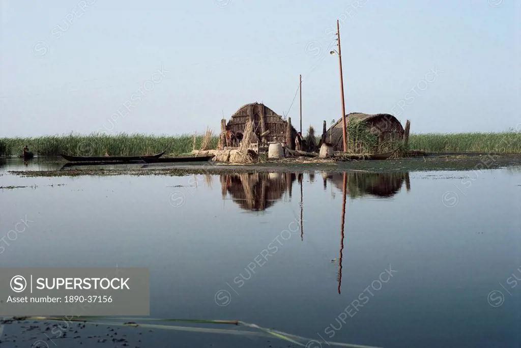 Reed houses and boat, Marshes, Iraq, Middle East