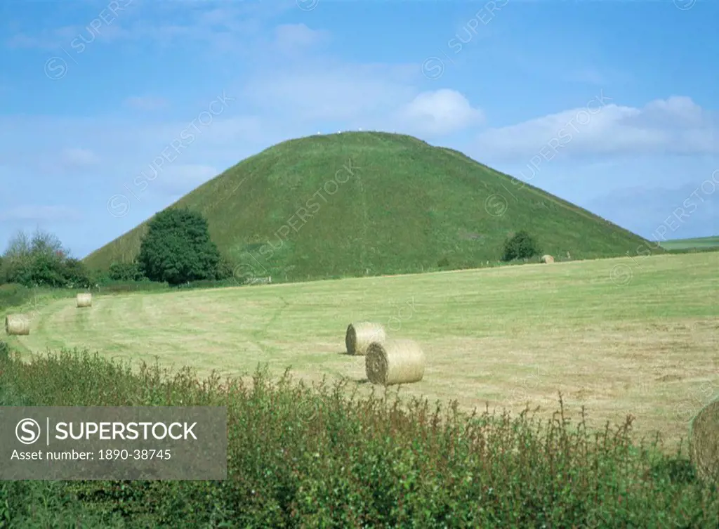 Baled hay in field below Silbury Hill, Wiltshire, England, United Kingdom, Europe