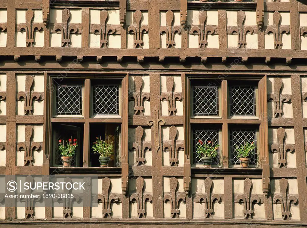 Detail of fleur_de_lys motif carved in wood on the timber framed Market Hall in the village of Arreau, Midi_Pyrenees, France, Europe