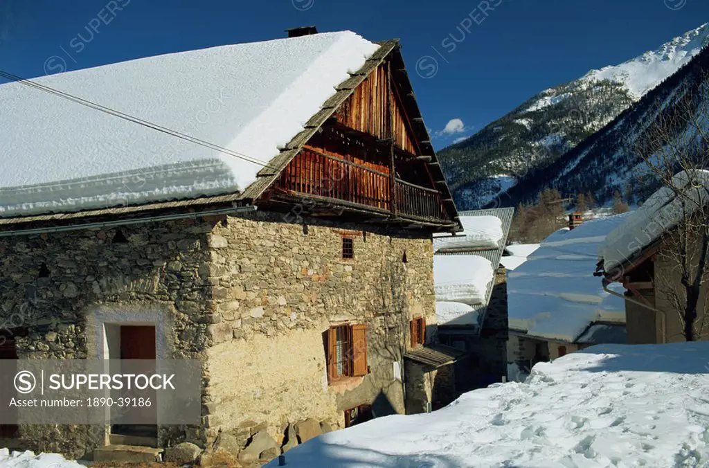 Houses covered in snow in the village of Nevache near Briancon, French Alps, France, Europe