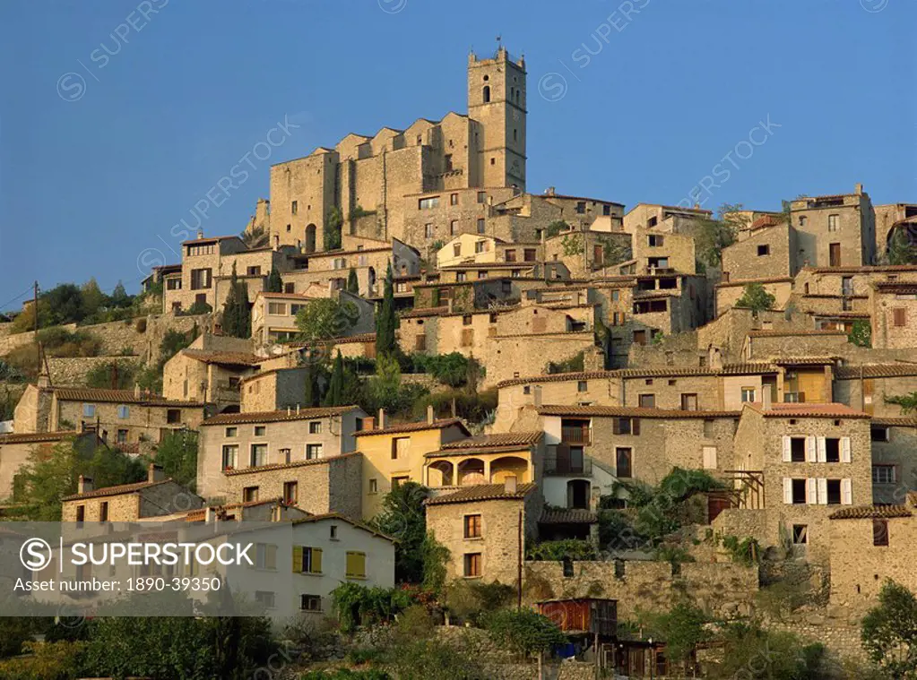 Christian church on the skyline and houses in the village of Eus, Languedoc Roussillon, France, Europe