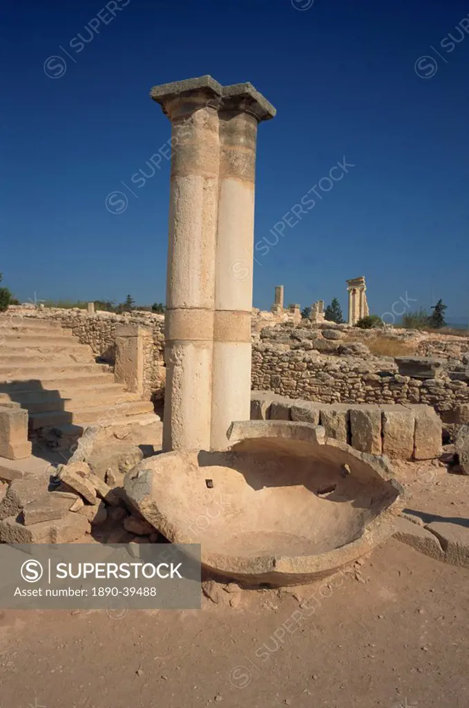 Stone pithos in the Palaestra with Temple of Apollo in the background in the ruins of Kourion, south Cyprus, Europe