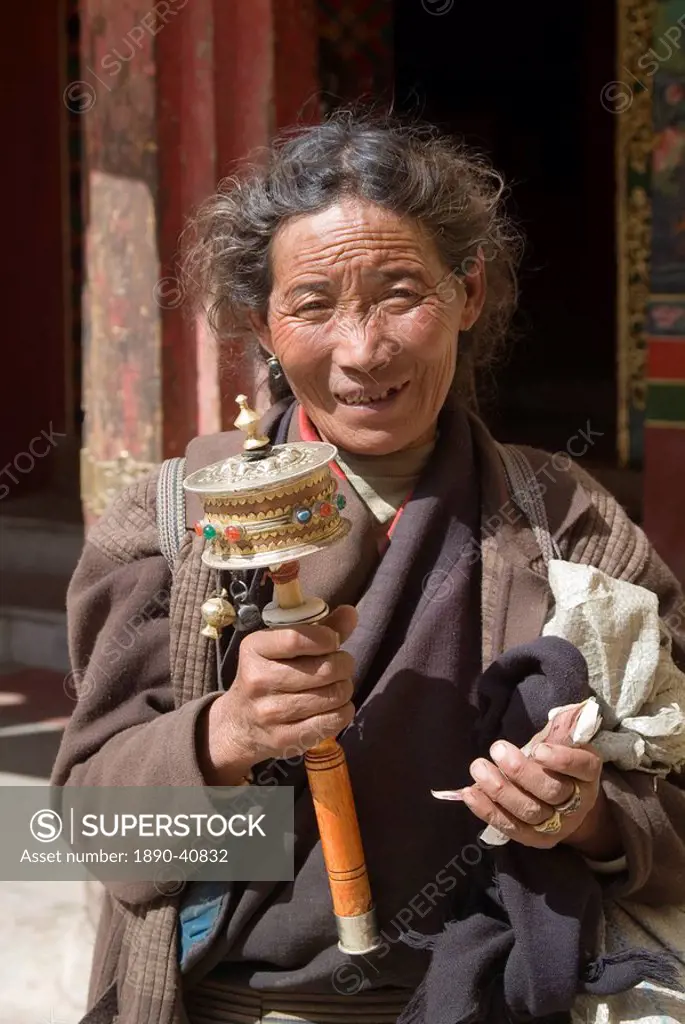 Woman and prayer wheel, Ganden Monastery, near Lhasa, Tibet, China, Asia