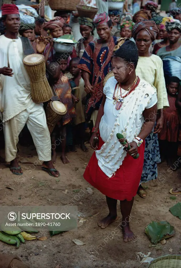 Female witch doctor in market place, Nigeria, Africa