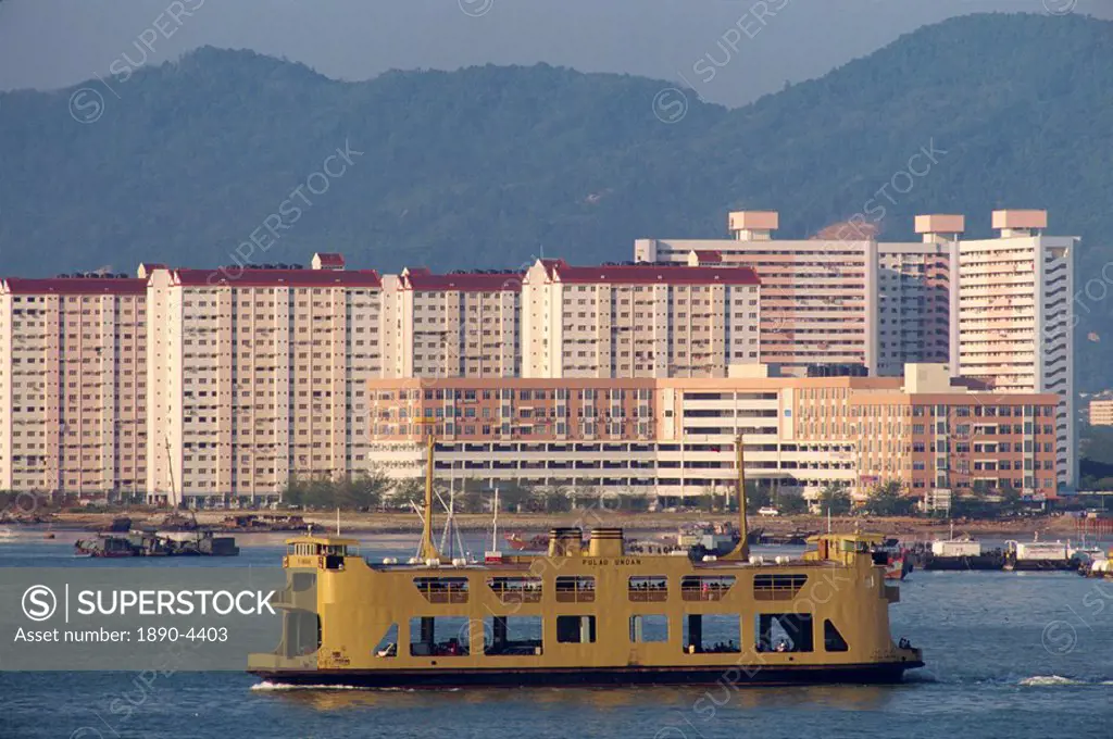 Ferry passing housing developments in Penang, Malaysia, Southeast Asia, Asia