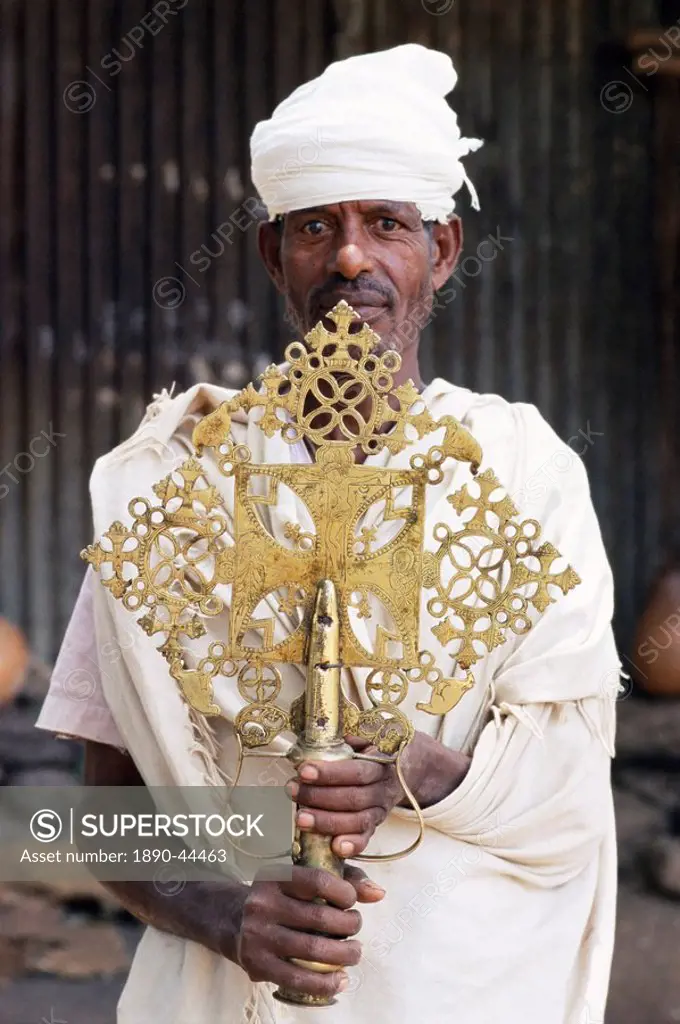 Portrait of a man holding a treasure from the Narga Selassie Christian church, island of Dek, Lake Tana, Gondar region, Ethiopia, Africa