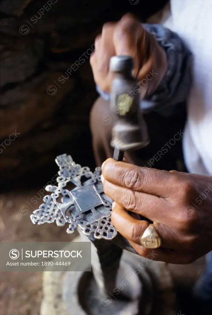 Close_up of blacksmith´s hands working on metal cross, Axoum Axum Aksum, Tigre region, Ethiopia, Africa