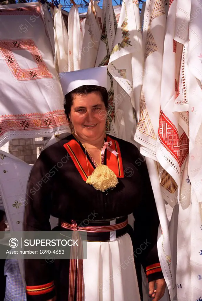 Stall holder in folk costume, Cilipi, Croatia, Europe