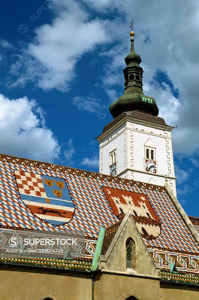 Close_up of tile roof with pattern of shields and clock tower of St. Marks church, Zagreb, Croatia, Europe