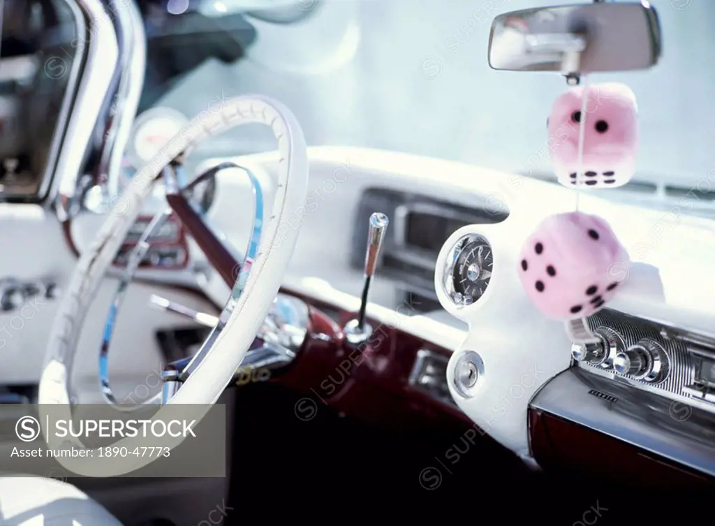Close_up of steering wheel and interior of a pink Cadillac car