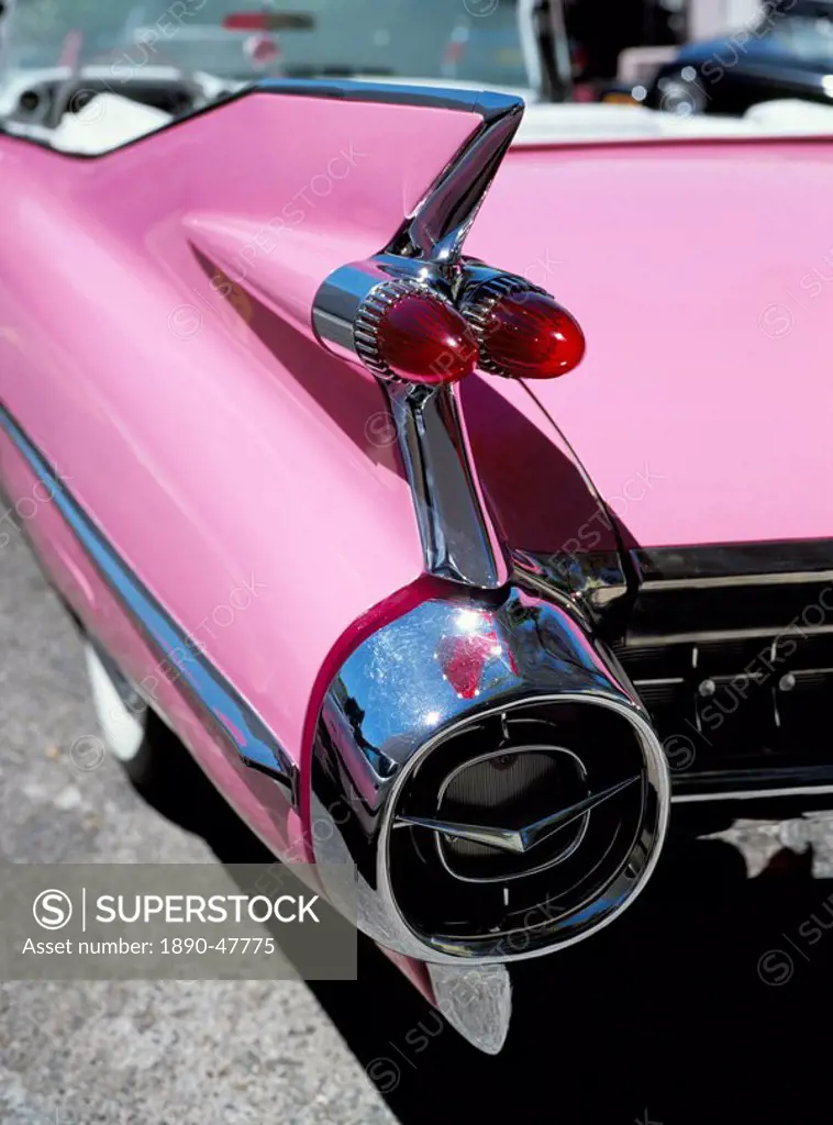 Close_up of fin and lights on a pink Cadillac car