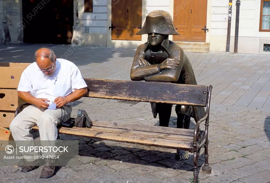 Man on park bench and statue of Napoleon, Hlavne Square, Bratislava, Slovakia, Europe