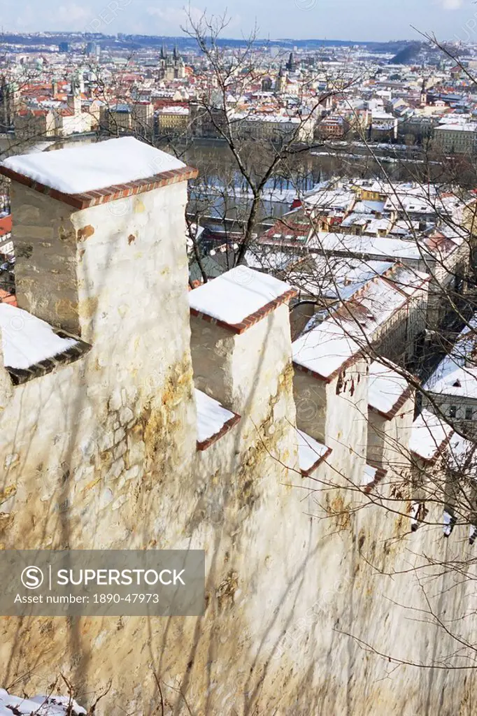 View of Prague from snow_covered Gothic Hunger Wall on Petrin Hill, Mala Strana, Prague, Czech Republic, Europe