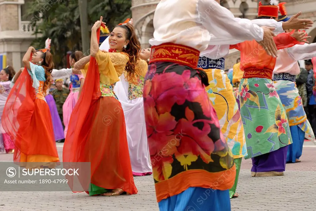 Malay female dancers wearing traditional dress at celebrations of Kuala Lumpur City Day Commemoration, Merdeka Square, Kuala Lumpur, Malaysia, Southea...