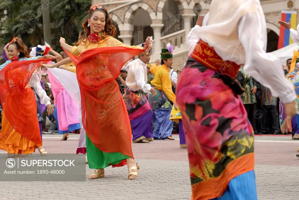 Malay female dancers wearing traditional dress at celebrations of Kuala Lumpur City Day Commemoration, Merdeka Square, Kuala Lumpur, Malaysia, Southea...