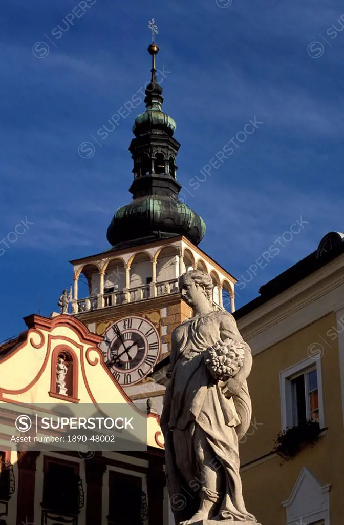 Close_up of statue on Nemesti and church clock tower of Mikulov, Mikulovska wine region, Mikulov, Brno Region, Czech Republic, Europe