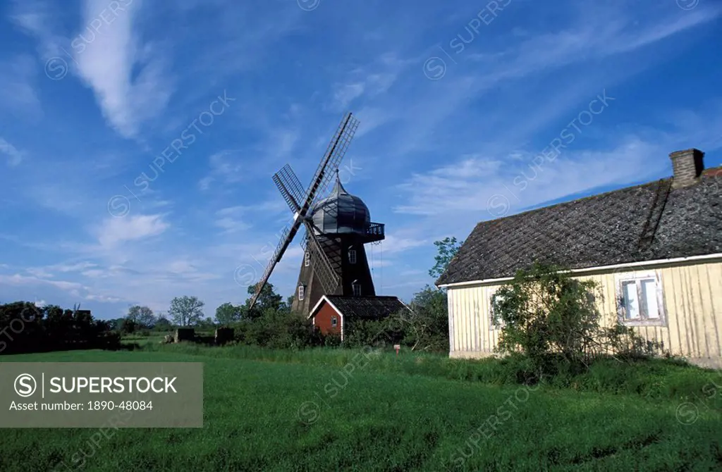 Landscape with wooden windmill and two houses in the village of Kvarnbacken, Oland Island, Sweden, Scandinavia, Europe