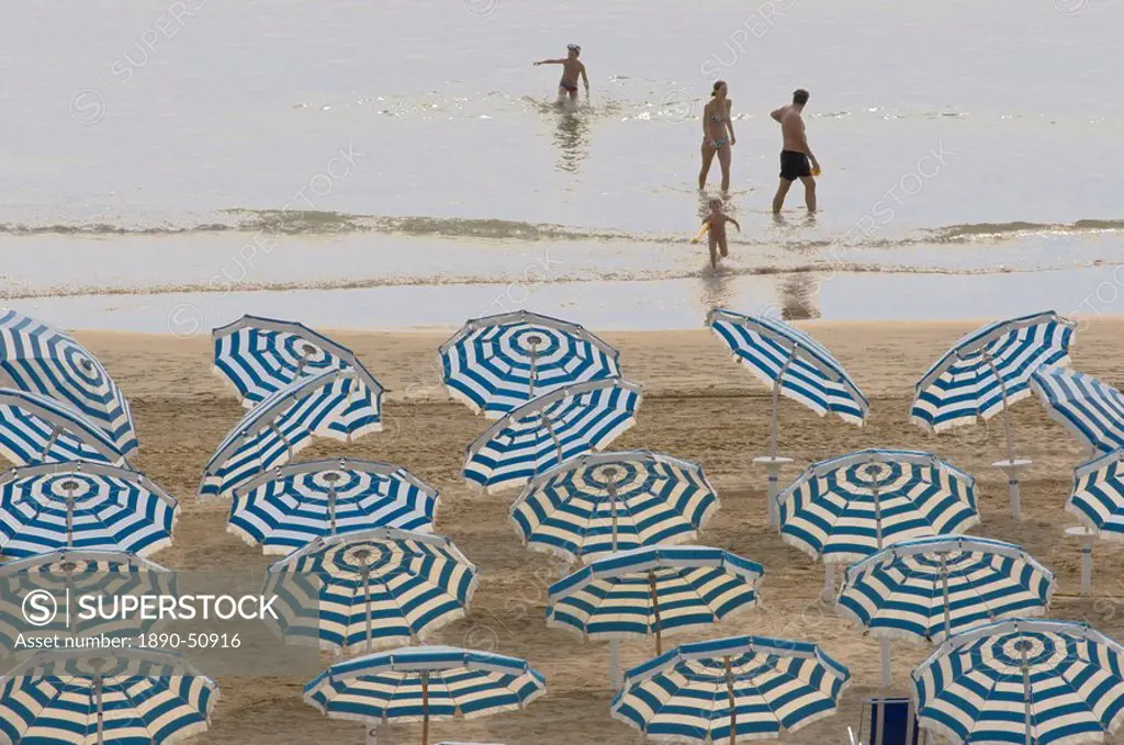 Umbrellas on the beach, family in the sea, Jesolo, Venetian Lagoon, Veneto, Italy, Europe