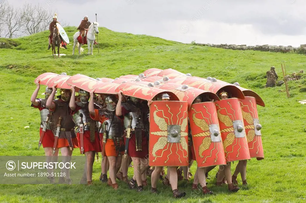 Ermine Street Guard advancing with protective shields, cavalry in attendance, Birdoswald Roman Fort, Hadrians Wall, Northumbria, England, United Kingd...