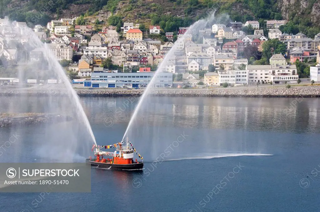 Dressed overall, with the traditional farewell display, the fireboat at Alesund, Norway, Scandinavia, Europe