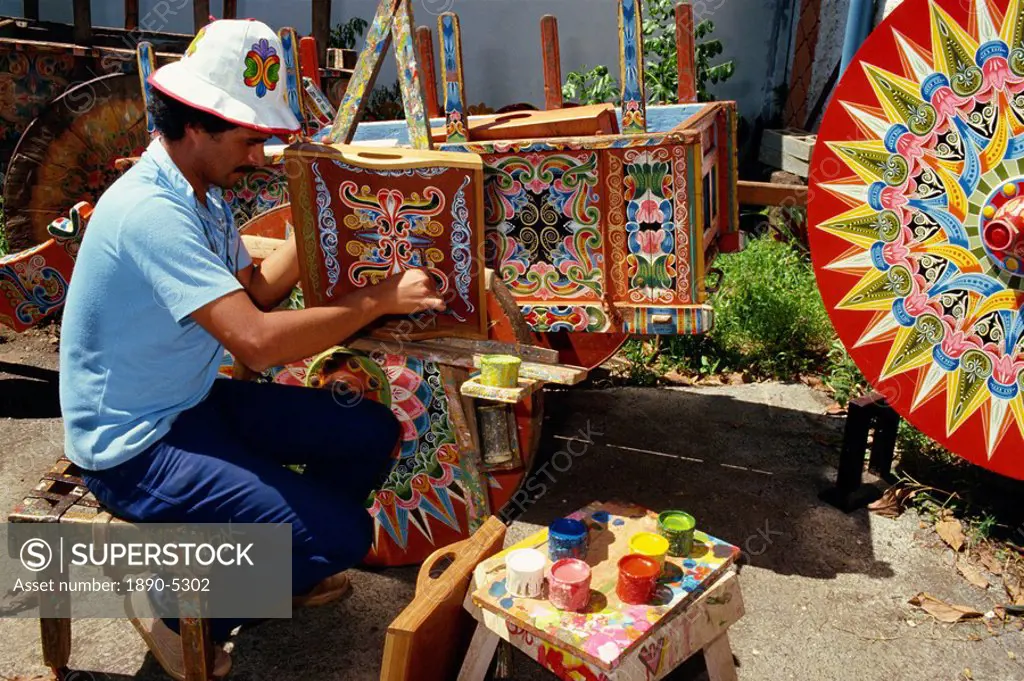 Portrait of a man with his paint pots painting traditional designs, at Sarchi in Costa Rica, Central America