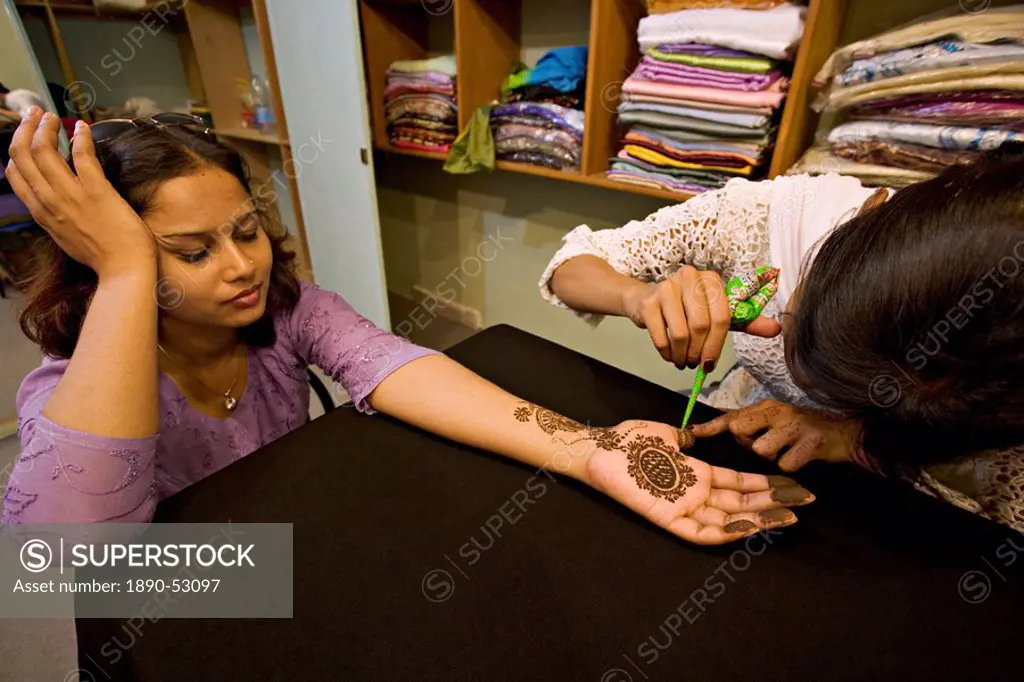 Woman has henna design applied to her hand at a beauty parlour and boutique in Rawalpindi, Pakistan, Asia
