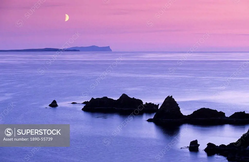 Sunset over Sand Wick and rising moon over Foula in distance, Eshaness, Shetland, Scotland, United Kingdom, Europe